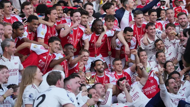Job done: Gunners' celebrate after season of change
